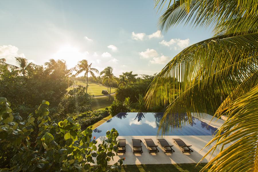 Pool surrounded by palms at sunrise, Las Terrazas