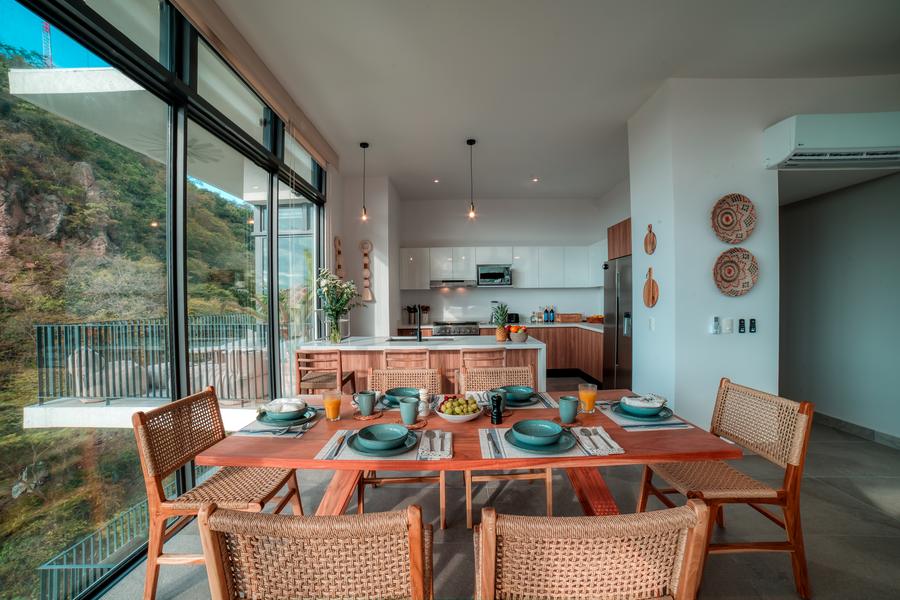 Open kitchen and dining area with floor-to-ceiling glazing